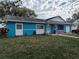 A single-story blue home with white trim features a front porch and attached garage at 3243 Little Sound Dr, Orlando, FL 32827
