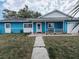 Charming single-story home with a blue exterior, white trim, front porch, and well-maintained lawn at 3243 Little Sound Dr, Orlando, FL 32827