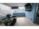 Relaxing sunroom with tile flooring, blue walls, and comfortable seating at 3243 Little Sound Dr, Orlando, FL 32827