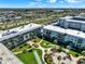 Wide aerial shot showcasing the expansive condominium complex with manicured grounds and shuffleboard courts at 325 N Causeway # 2080, New Smyrna Beach, FL 32169
