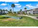 Well-maintained community grounds with lush landscaping, shuffleboard court, and walking paths for outdoor enjoyment at 325 N Causeway # 2080, New Smyrna Beach, FL 32169