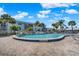 Community pool surrounded by lush landscaping and a spacious deck for lounging and enjoying the Florida sunshine at 325 N Causeway # 2080, New Smyrna Beach, FL 32169