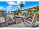 Outdoor fire pit area with comfortable rocking chairs, perfect for cozy evenings and gatherings with neighbors at 325 N Causeway # 2080, New Smyrna Beach, FL 32169