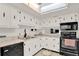Well-maintained kitchen with white cabinets, black appliances, and modern fixtures at 325 N Causeway # 2080, New Smyrna Beach, FL 32169