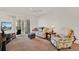 Bright living room with sliding glass doors to a balcony and comfortable seating at 325 N Causeway # 2080, New Smyrna Beach, FL 32169