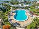 Beautifully landscaped community pool surrounded by tropical foliage and waterfront views at 325 N Causeway # 2080, New Smyrna Beach, FL 32169