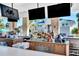 Outdoor bar showcasing a wide selection of beverages and multiple screens for an enjoyable entertainment experience at 3320 Lilac Way, Davenport, FL 33897