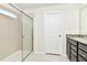 Bathroom featuring a glass shower and vanity with granite counters and dark wood cabinets at 3320 Lilac Way, Davenport, FL 33897