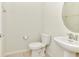 Cozy powder room with a pedestal sink, toilet and tile flooring at 3320 Lilac Way, Davenport, FL 33897