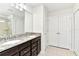 Spacious primary bath with double vanity sinks, granite counters, and tiled floors at 3320 Lilac Way, Davenport, FL 33897