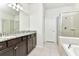 Bright bathroom featuring granite counters, double sinks, and a glass-enclosed shower at 3320 Lilac Way, Davenport, FL 33897