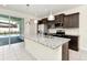 Open concept kitchen with granite counters, stainless appliances, tile backsplash, and island with pendant lights at 3320 Lilac Way, Davenport, FL 33897