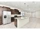 Kitchen with stainless steel appliances, granite countertops, island with pendant lights, and tile floor at 3320 Lilac Way, Davenport, FL 33897