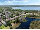 Beautiful aerial view featuring a home next to a lush lake surrounded by mature trees at 3655 Seminole Dr, Orlando, FL 32812