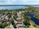 Scenic aerial view of a neighborhood with homes backing up to a picturesque lake, and mature trees at 3655 Seminole Dr, Orlando, FL 32812