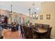 Open concept dining room with hardwood floors, a chandelier, and easy access to the living area at 3655 Seminole Dr, Orlando, FL 32812