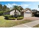 Charming single-story home with a two-car garage, well-manicured landscaping, and beautiful palm trees at 3655 Seminole Dr, Orlando, FL 32812