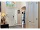 Bright and inviting foyer with a decorative front door, high ceilings, and a view into the living area at 3655 Seminole Dr, Orlando, FL 32812