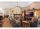 Cozy living room with a fireplace, entertainment center, comfortable seating, and ample natural light at 3655 Seminole Dr, Orlando, FL 32812