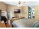 Comfortable main bedroom featuring hardwood floors, ample natural light, and a view of the en suite bathroom at 3655 Seminole Dr, Orlando, FL 32812