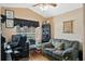 Functional home office with a comfortable sofa, desk, and a sunlit window at 3655 Seminole Dr, Orlando, FL 32812