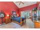 Comfortable bedroom featuring bright red walls and natural light at 3901 Villas Green Cir # 1, Longwood, FL 32779