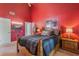 Cozy bedroom featuring bright red walls and comfortable furnishings at 3901 Villas Green Cir # 1, Longwood, FL 32779