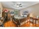Warm and inviting bedroom featuring hardwood floors and ample natural light at 3901 Villas Green Cir # 1, Longwood, FL 32779