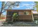 Charming brown exterior with screened porch, wood railing and lattice work beneath the home at 3901 Villas Green Cir # 1, Longwood, FL 32779