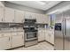 Well-lit kitchen with stainless steel appliances, tile backsplash, and ample countertop space at 3901 Villas Green Cir # 1, Longwood, FL 32779