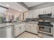 Bright kitchen featuring stainless steel appliances, white cabinets, and granite countertops at 3901 Villas Green Cir # 1, Longwood, FL 32779
