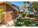 Side yard with walkway, greenery and brick facade at 3901 Villas Green Cir # 1, Longwood, FL 32779