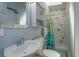 Cozy bathroom featuring a vanity sink, toilet, and shower with marble-like tile, offering a clean design at 427 Zimmerman Dr, Orlando, FL 32839