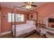 Charming bedroom featuring a four-poster bed, hardwood floors, a ceiling fan, and a cozy atmosphere at 427 Zimmerman Dr, Orlando, FL 32839