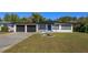 Charming one-story home with a well-manicured lawn and a bright blue front door, enhancing curb appeal at 427 Zimmerman Dr, Orlando, FL 32839