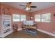 Bright home office with hardwood floors, ceiling fan, and natural light from two windows at 427 Zimmerman Dr, Orlando, FL 32839