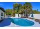 Backyard swimming pool with lounge chairs, patio furniture, and lush tropical landscaping creating a private oasis at 427 Zimmerman Dr, Orlando, FL 32839