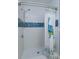 Shower with blue tile accent stripe and decorative peacock shower curtain at 427 Zimmerman Dr, Orlando, FL 32839