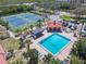 Aerial view of pool and tennis courts with surrounding amenities at 434 Bouchelle Dr # 202, New Smyrna Beach, FL 32169