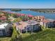 Aerial view of a waterfront community showing the condo building, red roofs, and waterway at 434 Bouchelle Dr # 202, New Smyrna Beach, FL 32169