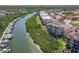 Scenic view of waterfront condos along a river with boat docks and lush greenery at 434 Bouchelle Dr # 202, New Smyrna Beach, FL 32169
