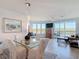 A dining room and sitting area featuring floor to ceiling windows at 434 Bouchelle Dr # 202, New Smyrna Beach, FL 32169