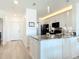 Bright kitchen with white cabinetry, granite countertops, modern appliances, and hardwood floors at 434 Bouchelle Dr # 202, New Smyrna Beach, FL 32169
