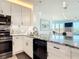 Stylish kitchen featuring modern appliances, granite counters, and white cabinetry at 434 Bouchelle Dr # 202, New Smyrna Beach, FL 32169