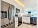 Updated kitchen featuring stainless steel appliances, modern white cabinets, and stone countertops at 434 Bouchelle Dr # 202, New Smyrna Beach, FL 32169