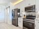 Modern kitchen with stainless steel appliances, granite counters, and white shaker cabinets at 434 Bouchelle Dr # 202, New Smyrna Beach, FL 32169