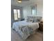 Serene bedroom with nautical decor, a cozy bed, and bright natural light at 434 Bouchelle Dr # 202, New Smyrna Beach, FL 32169