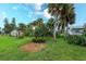 Expansive backyard with lush greenery, mature trees, and a brick patio at 476 Zelda Blvd, Daytona Beach, FL 32118