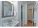 Well-lit bathroom featuring a modern sink, chrome fixtures, and a decorative mirror at 476 Zelda Blvd, Daytona Beach, FL 32118