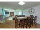 Bright dining area featuring hardwood floors, large table, seamlessly connected to living, ideal for gatherings at 476 Zelda Blvd, Daytona Beach, FL 32118